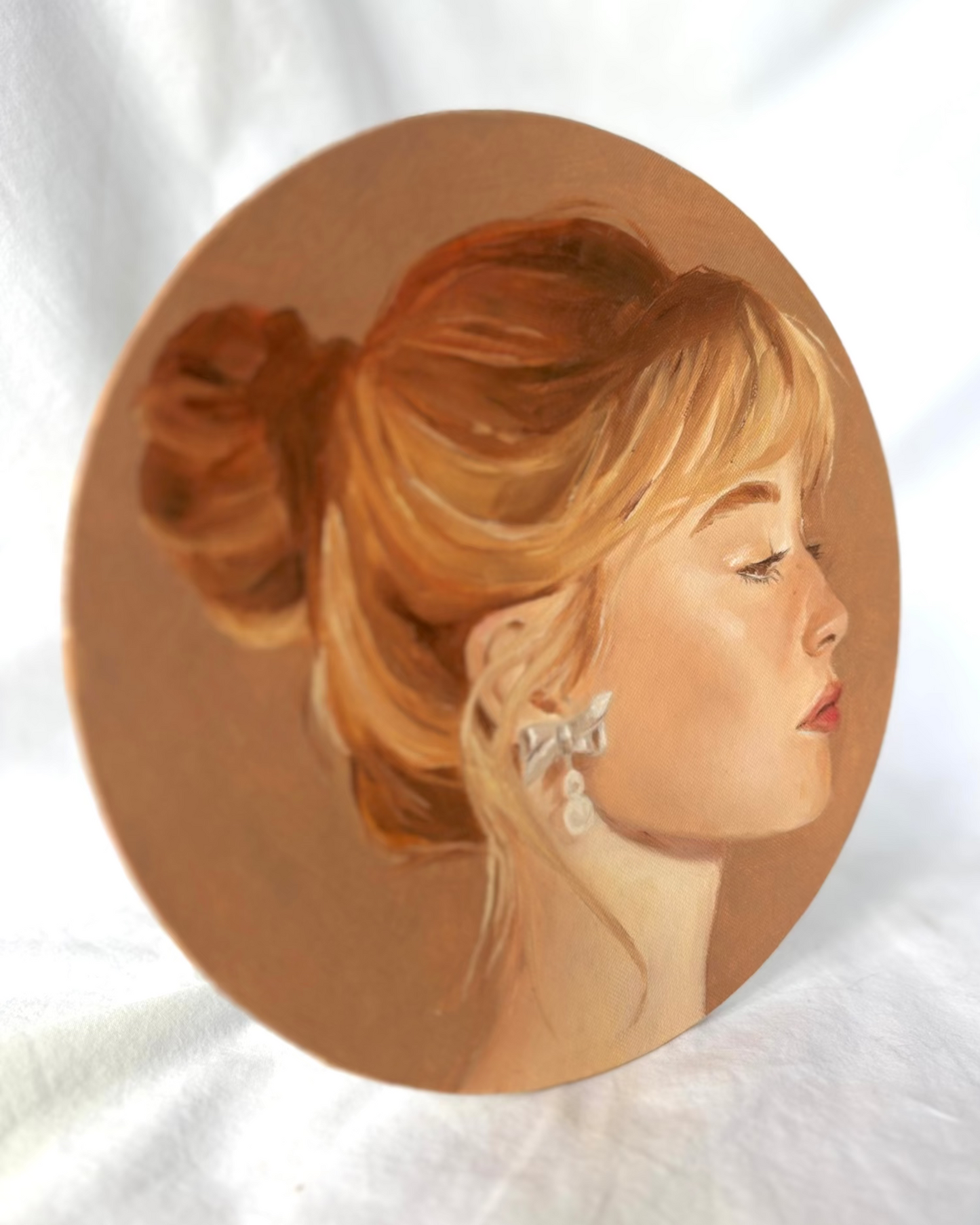 Circular portrait of a woman with ginger hair and a white background