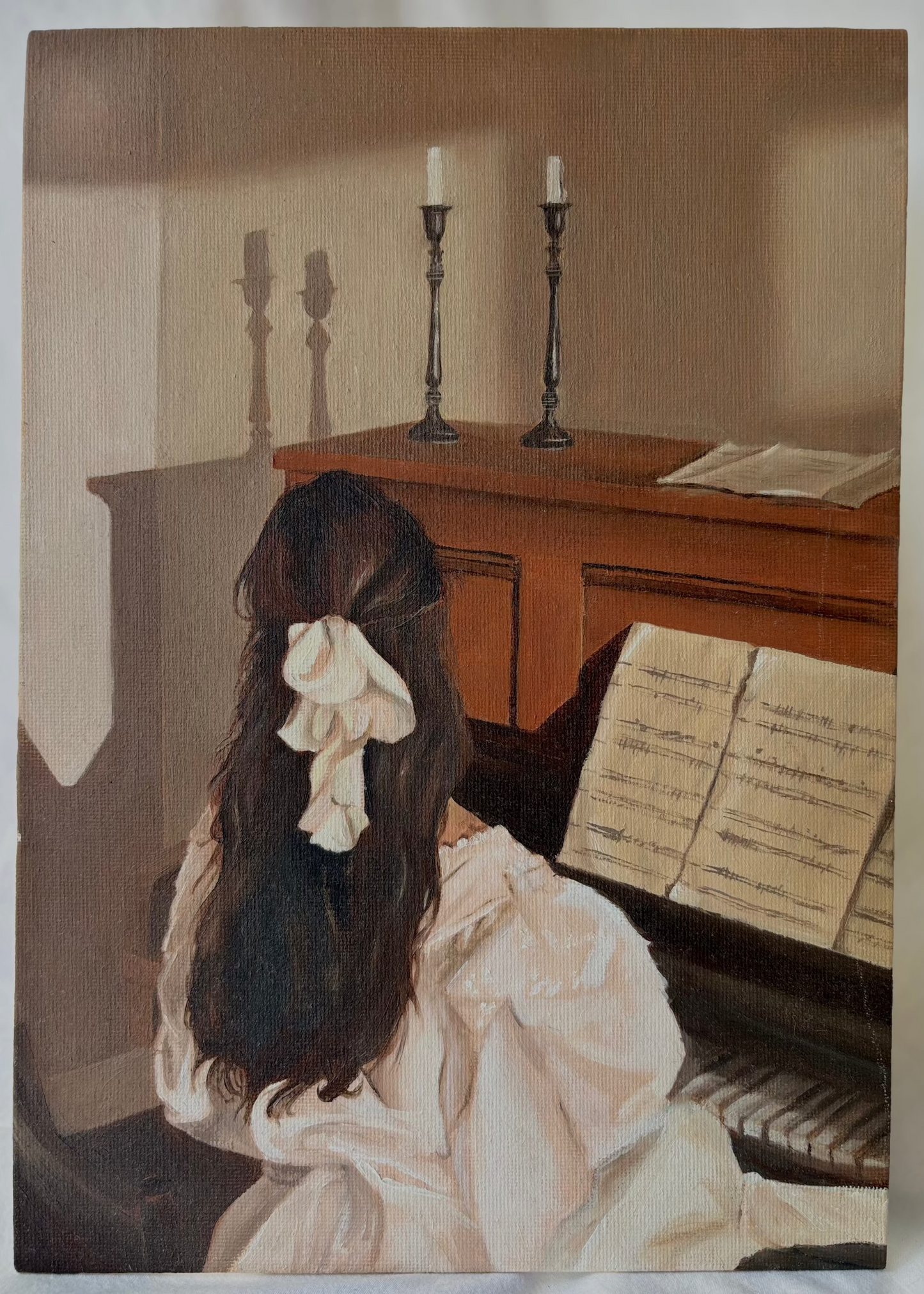 Painting of a woman sitting at a piano with candles in the background
